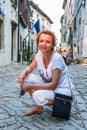 Young woman posing in street in Groznjan, Croatia